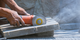 A person using a stone saw.